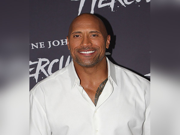 Dwayne 'The Rock' Johnson reacts to seeing himself blown up as fanny pack balloon in Thanksgiving parad