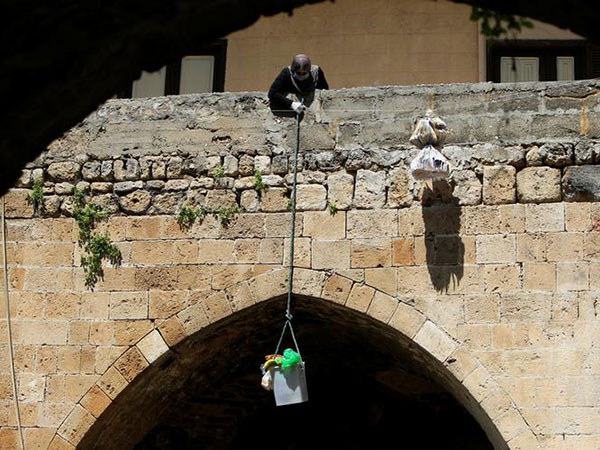 Baskets of solidarity lowered from Naples balconies amid coronavirus chaos