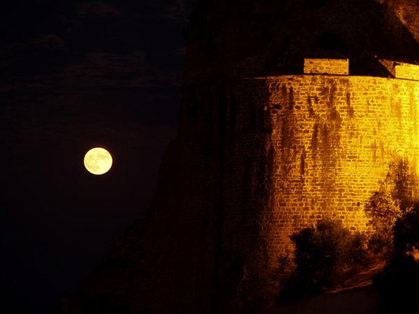 Full moon casts a glow by Greece's Koroni castle