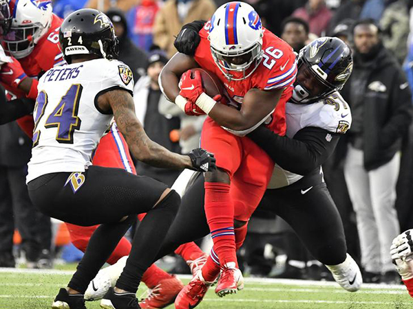 Buffalo Bills' Tre'Davious White sneaks a peak at Baltimore Ravens' play sheets blown onto field