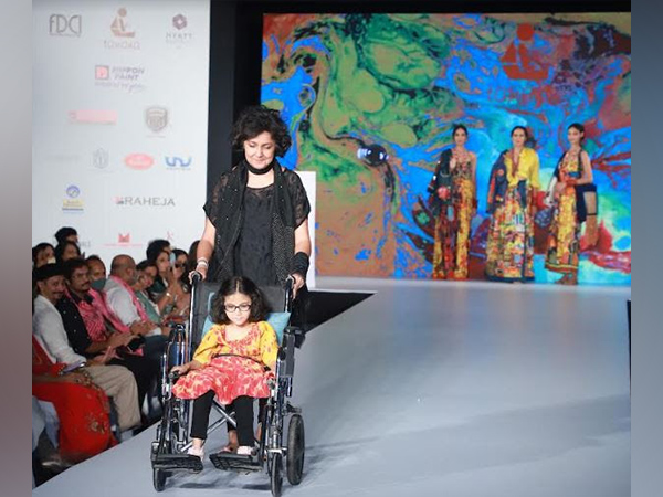Payal Jain walking the ramp with Intelectually Disabled child