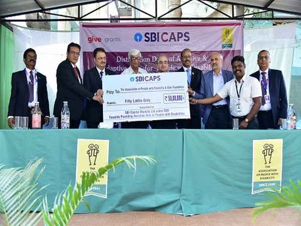 Dinesh Khara, Chairman, SBI, presenting a cheque to the Association of People with Disability, while launching a CSR program where assistive devices will be distributed to persons with disabilities