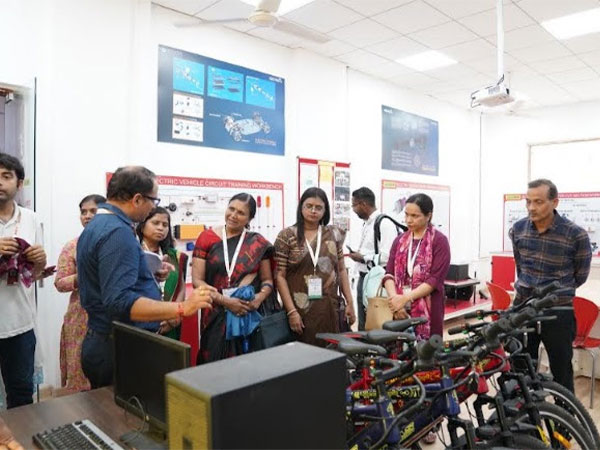 Guests of the event examining E-Bike manufactured by Galgotias University students in the Electric Vehicle Lab (EV Lab) on campus