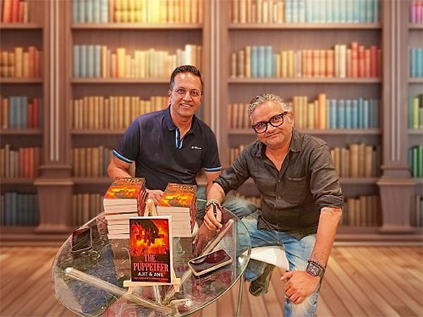 Ajit Menon (left) and Anil Verma (right) with their bestseller The Puppeteer