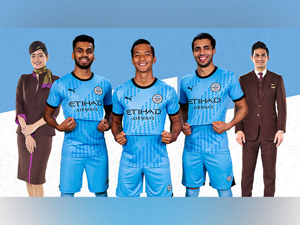 Mumbai City FC players Brandon Fernandes, Lallianzuala Chhangte and Vikram Partap Singh pose in the new jersey with the Etihad Airways logo