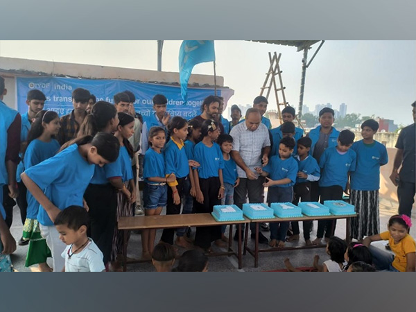 Children and volunteers gather for a celebratory moment during the event