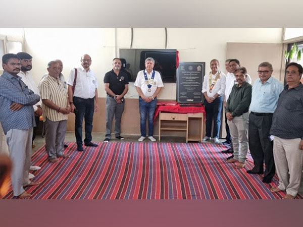 President Srinivasu Saraswatula seen with other members at a school