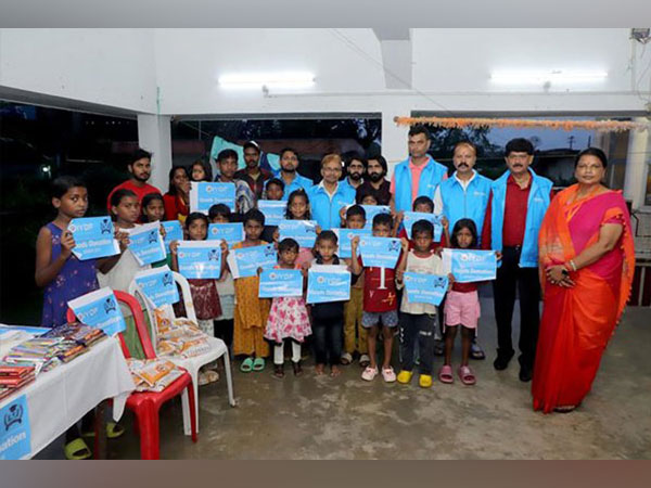 Volunteers and children proudly display IYDF donation signs.