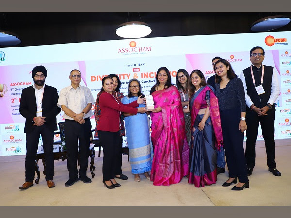 Lipika Mohanty, Director of People and Development at BUSINESSNEXT, and her team while receiving the award