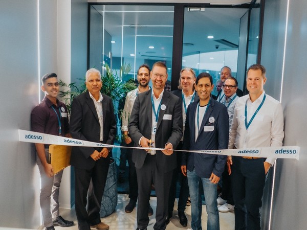 Mark Lohweber, CEO of adesso SE, cutting the ribbon, in the frame with Torsten Wegener, Burak Bari, Hansjorg Suess, Markus Lunsmann, Luck Michel, Shali Hassan, Pramod Murlidharan, and Krishna Sagar