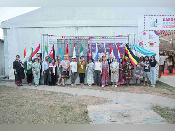 International crafts people at SIACF 2024 posing with the flags of their countries