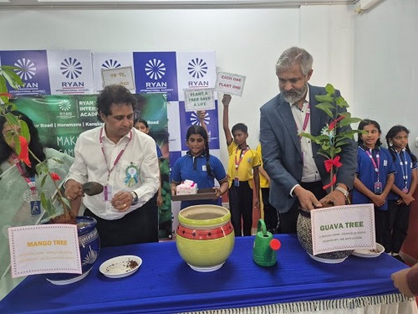Rotarians Mahesh Hariharan and Neil Michael Joseph plant trees at RIA, Horamavu, promoting a green future through the "Each One Plant One" initiative