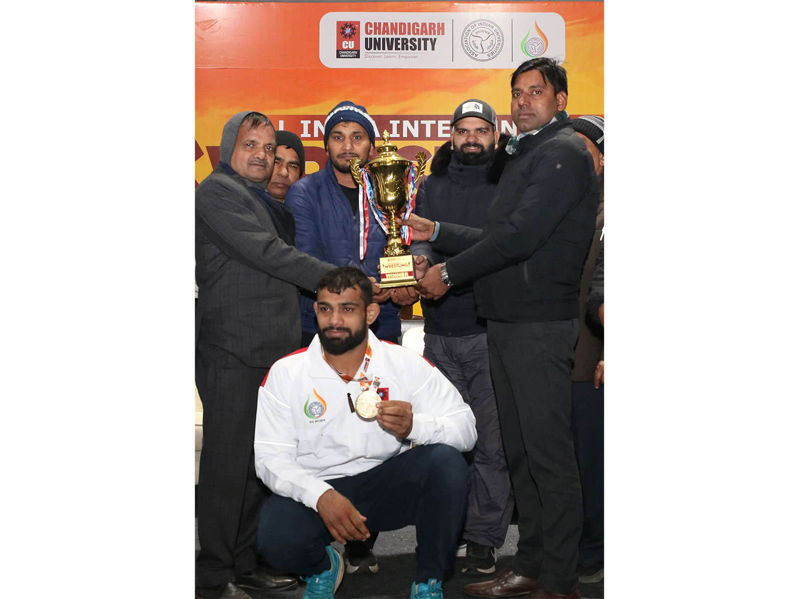 Chandigarh University wrestling medalists along with University officials receiving the overall champions trophy in AIU Wrestling Championship held at Chandigarh University