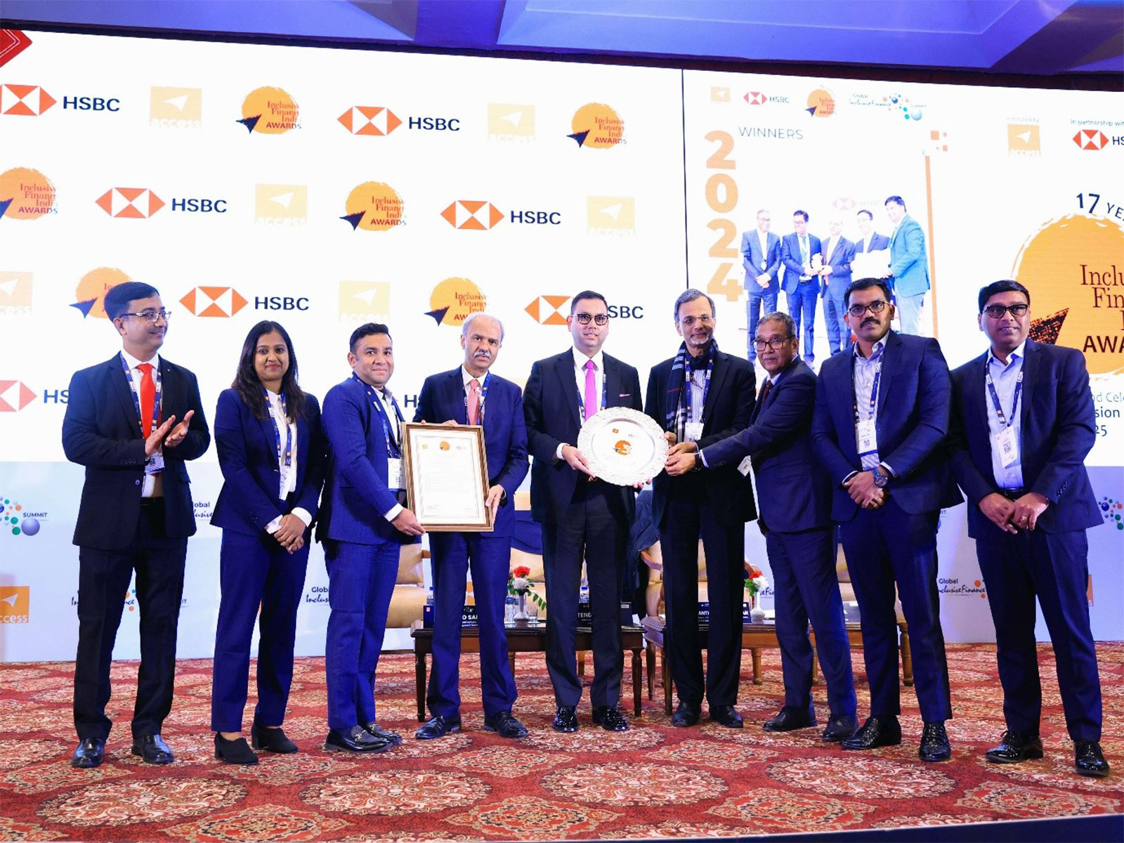 Senior leadership of Muthoot Microfin Limited receiving the 'Financial Inclusion Institution of the Year' award at the Inclusive Finance India Awards