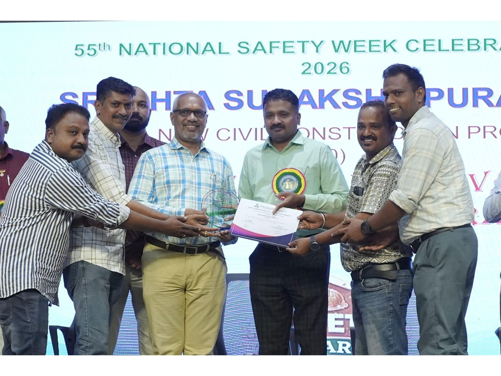 Mr. Deepu C, Sr. Project Engineer, Mr. Rajaram R, Assistant General Manager and Mr. Giri S Nair, General Manager from the Company Veegaland Homes receiving award from dignitaries