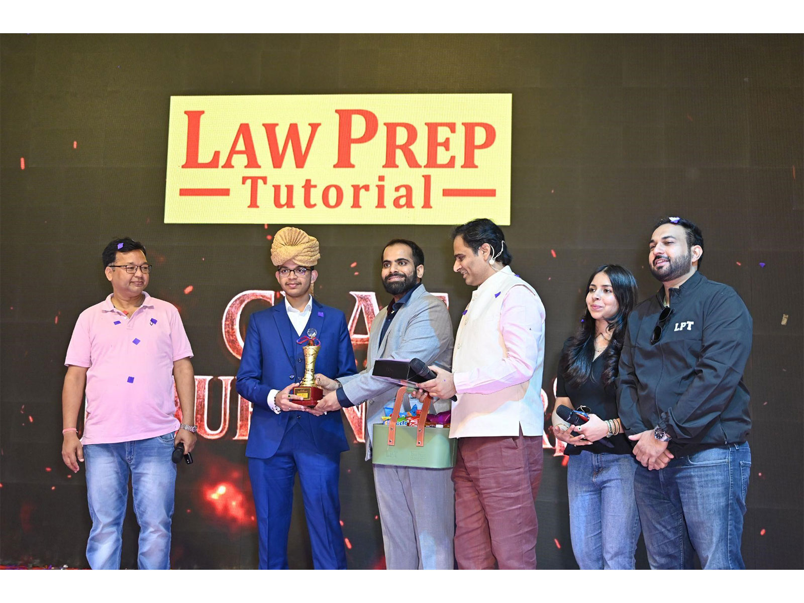 'Founder Sagar Joshi, Law Prep Tutorial NCR Director Mr. Anand Sharma with Priyam Rastogi, Eikluvya Murray Felicitating AILET 2026 Topper Aryan Singh'