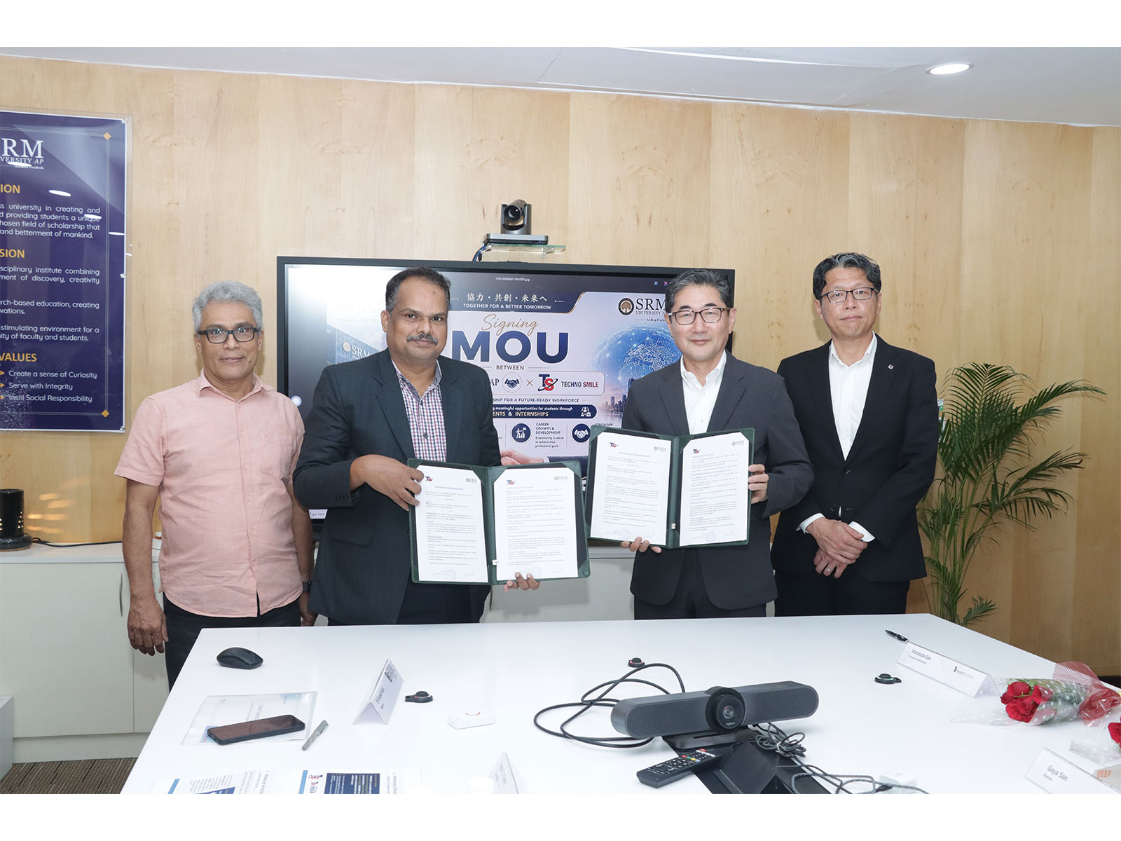 SRM University- AP Registrar Dr Vinayak Kalluri (left) and Technosmile President Yuzuru Mamizuka exchange the signed MoU