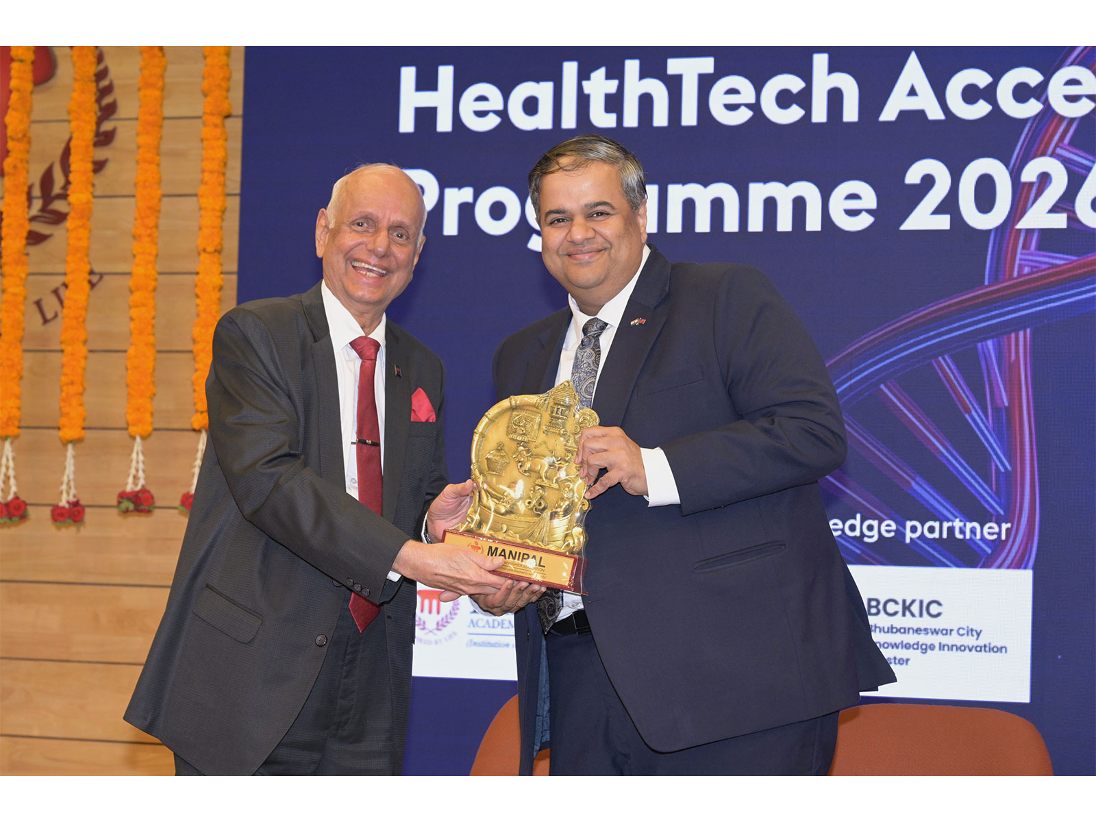Dr. H S. Ballal, Pro Chancellor of MAHE, presents a memento to Mr. Chandru Iyer, the British Deputy High Commissioner to Karnataka, during the programme's inauguration