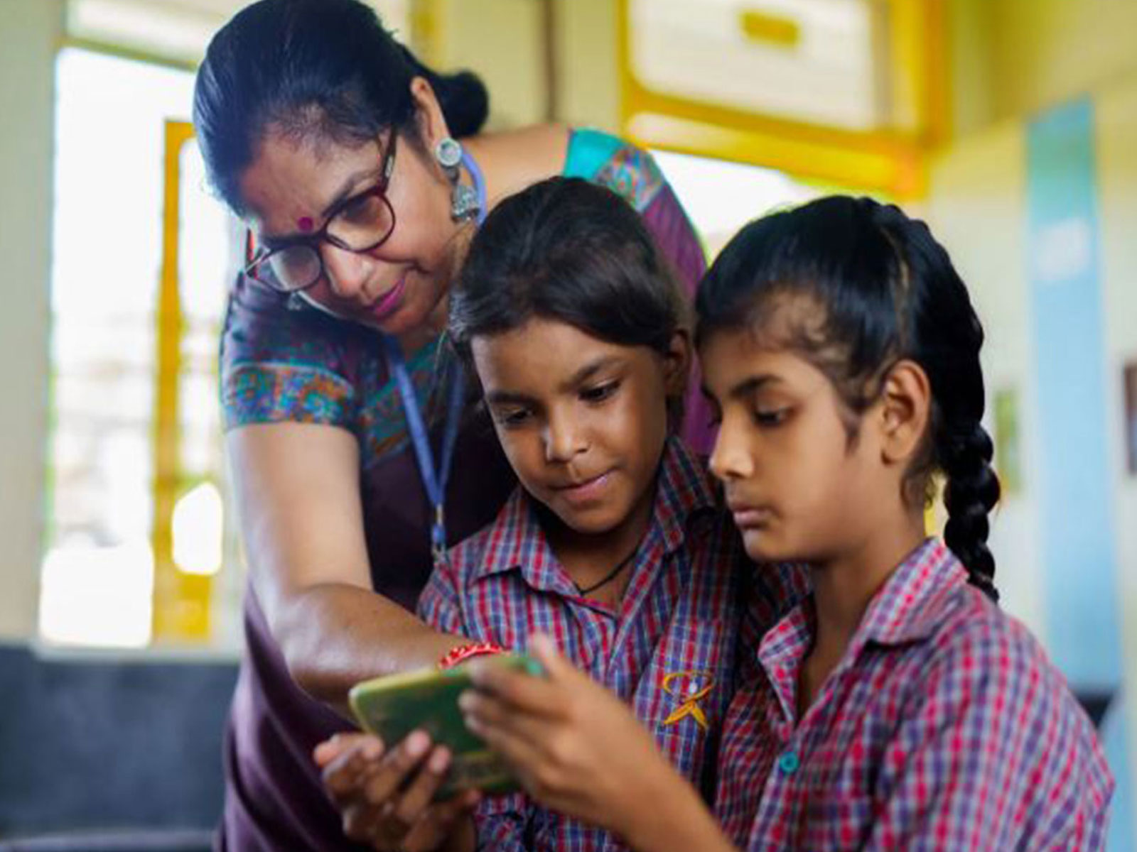 A teacher demonstrates an EdTech app to her students, part of ShikshaNext's  market-shaping push to bring proven digital tools into Indian classrooms
