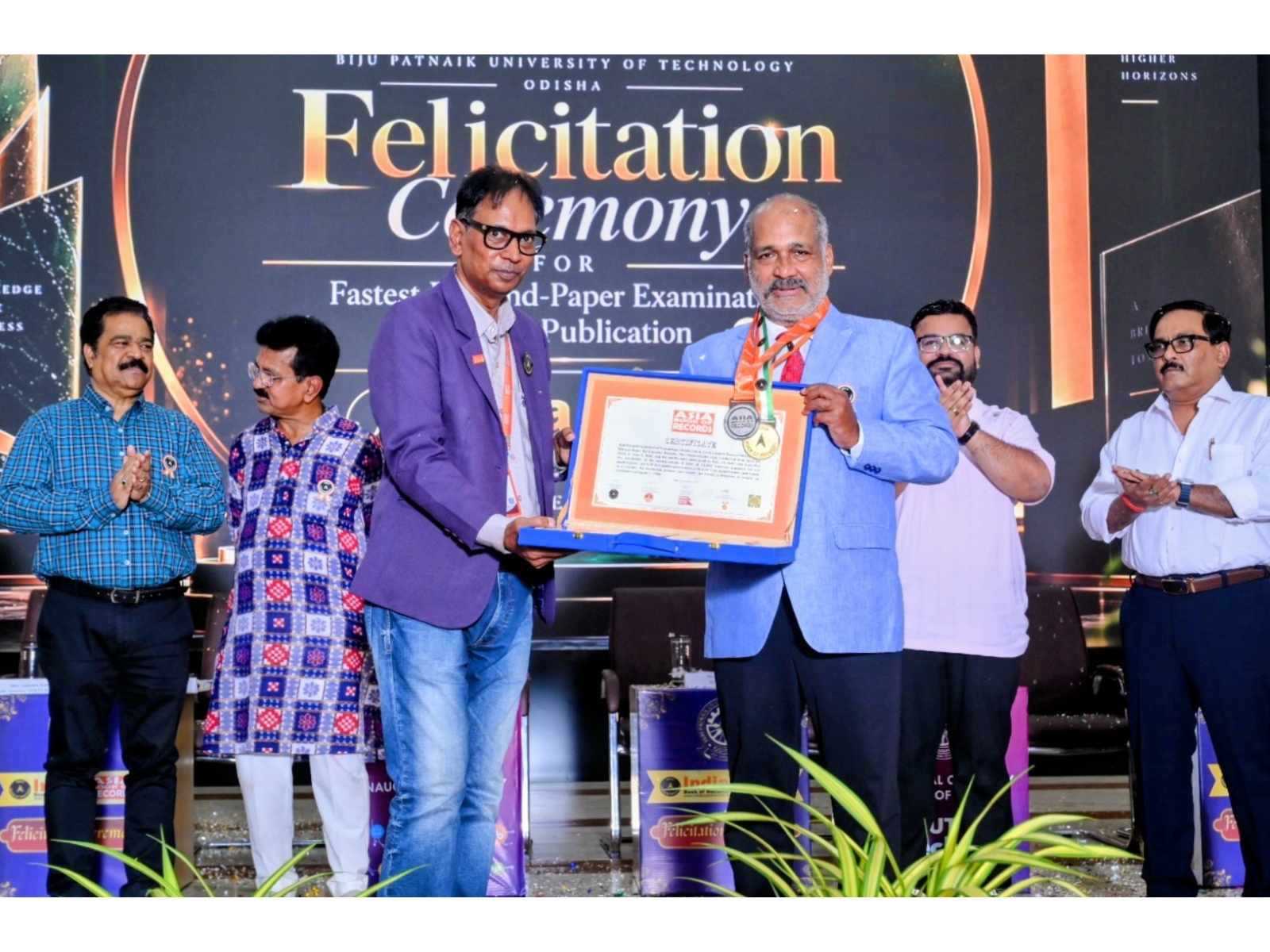 Vice Chancellor Prof. Amiya Kumar Rath (right) receives the Asia Book of Records