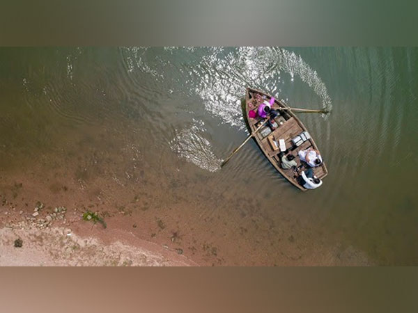 28 years old Mukesh Maida, a doctor, travels in a boat with his team to conduct vaccination session in a remote village in Ramgarh, Banswada