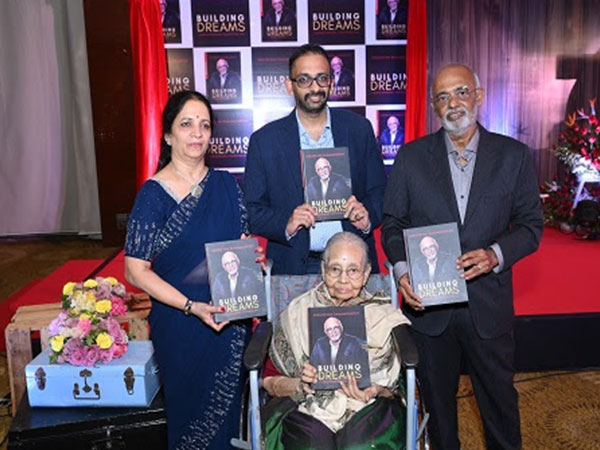 Thangam Moorthy (seated) launching the book "Building Dreams".  Seen in the picture is Vasudevan Ramamoorthy (extreme right) alongwith his family