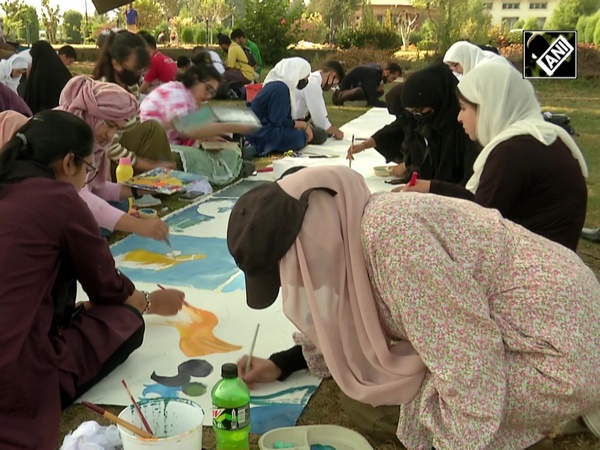 Students enjoy Joint Painting on long canvas during autumn season in Kashmir