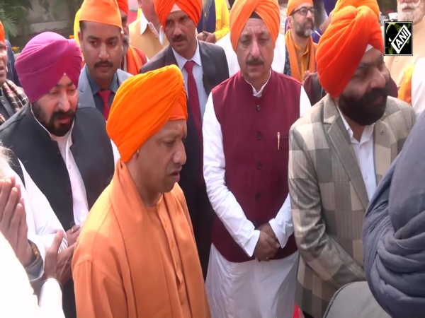 CM Yogi Adityanath walks with palanquin carrying Sikh holy book on his head on Veer Bal Diwas